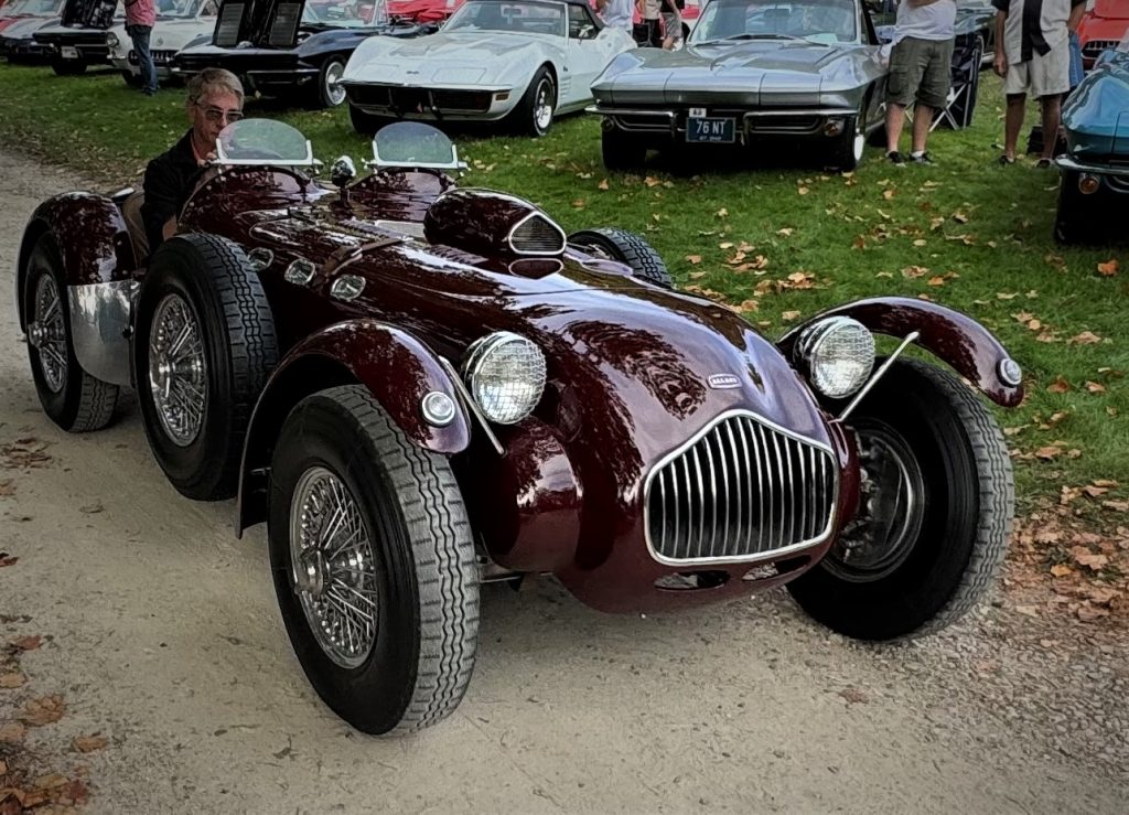 Vintage allard race car at a concours event