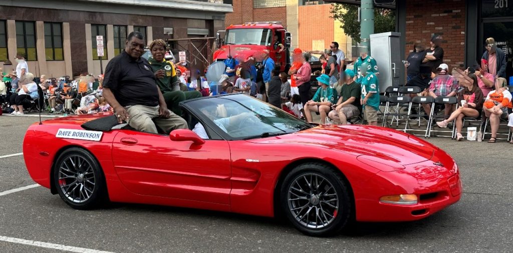 Man riding in a corvette in a parade