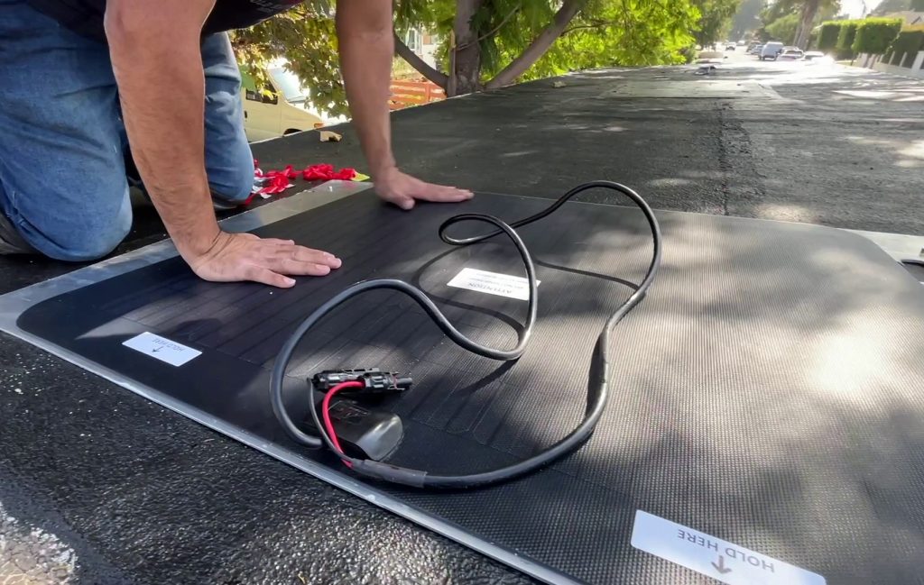 Pressing Cascadia 4x4 solar panel in place