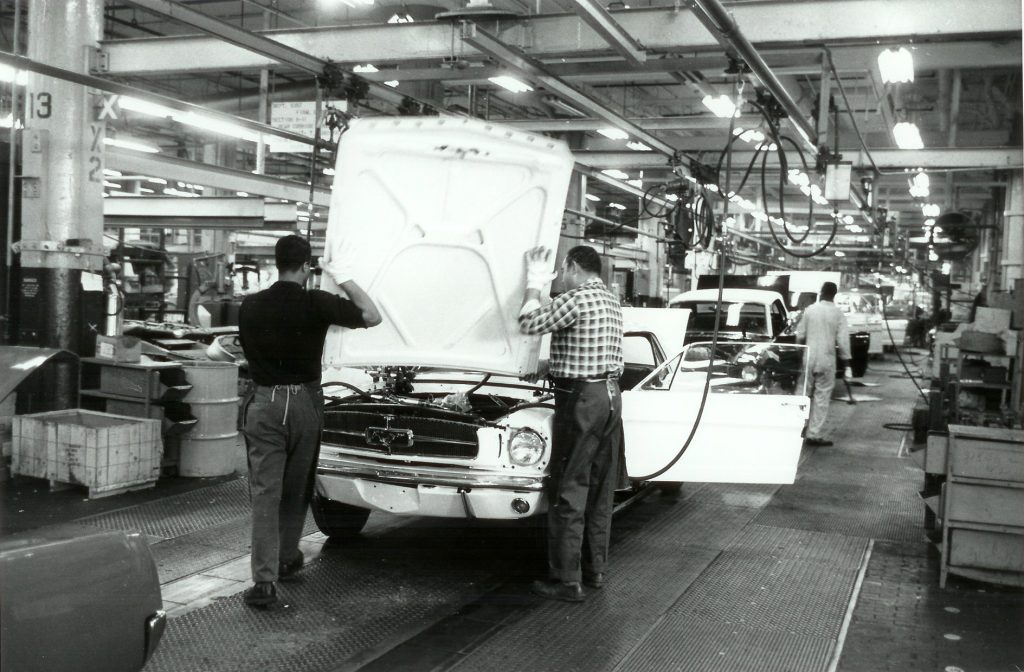 Workers assembling 1964 Mustangs