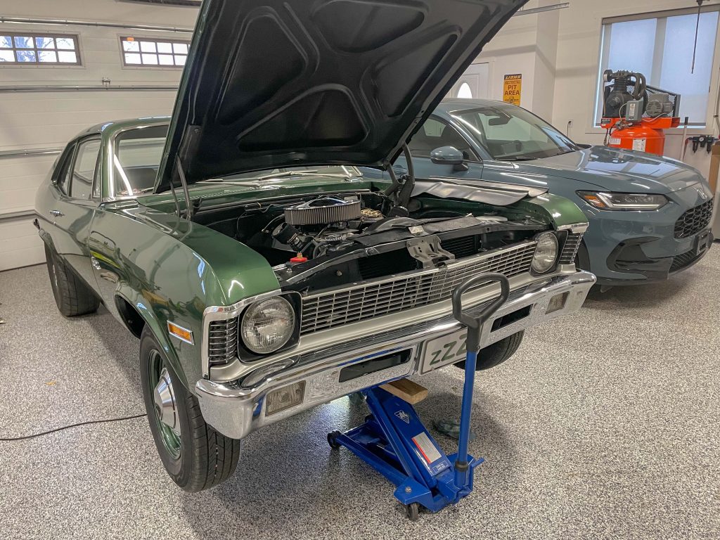 Lifting front of Chevy Nova with floor jack