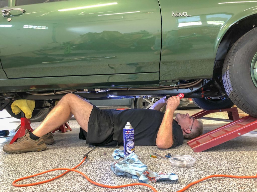 Wayne Scraba working under Chevy Nova