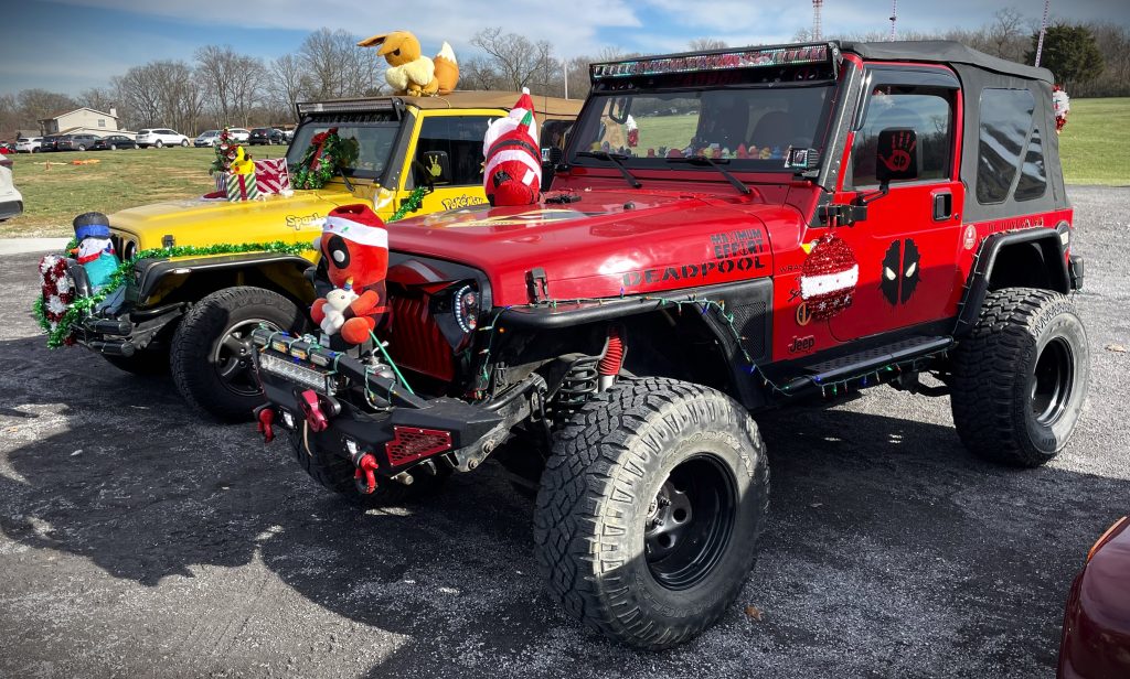 a pair of Jeep Wranglers decorated for Christmas