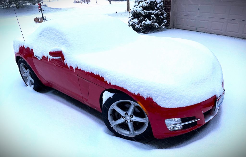 saturn sky roadster covered in snow