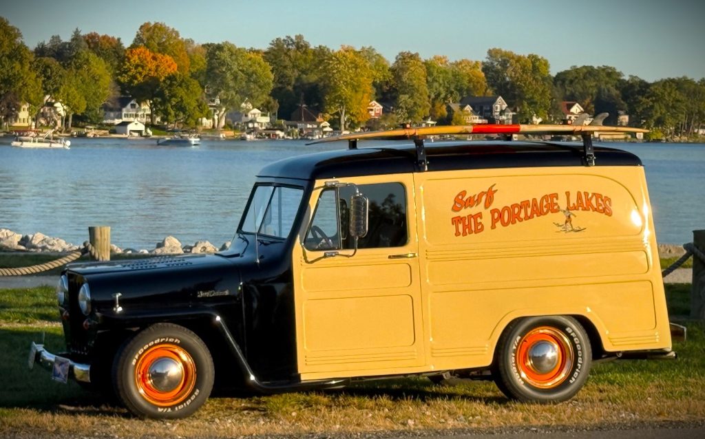 a custom 1948 Jeep Surf Panel Wagon near lake